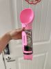 Portable 4-in-1 Pet Water Bottle With Food Storage, Poop Bag Dispenser, and Spoon. 300ml Capacity. Available In Yellow, Pink, Green, and Other Colors.